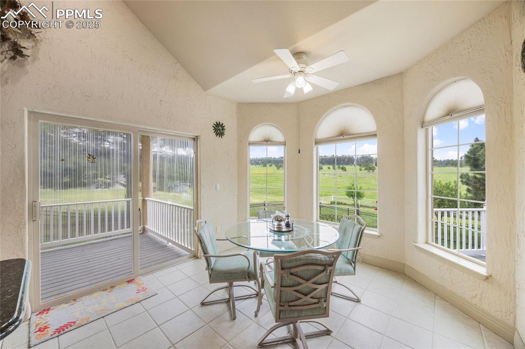 Image 23 of 41: Sunroom featuring a textured wall, plenty of natural light, tile patterned 