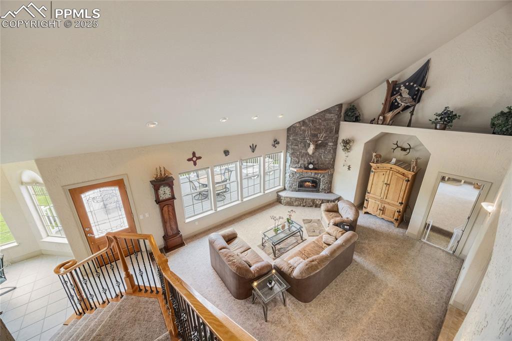 Image 24 of 41: Living room featuring healthy amount of natural light, lofted ceiling, a st