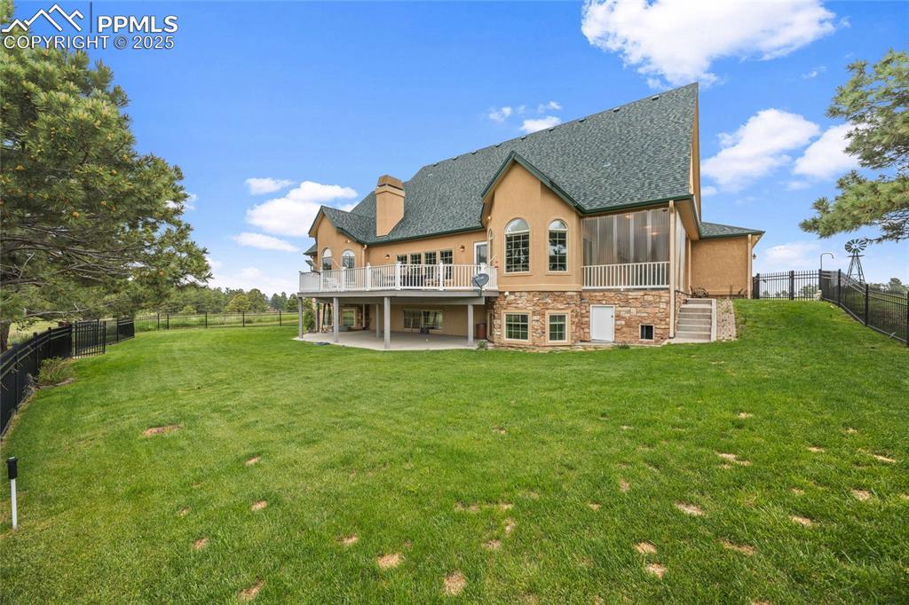 Image 5 of 41: Back of house with roof with shingles, a patio area, a fenced backyard, a s