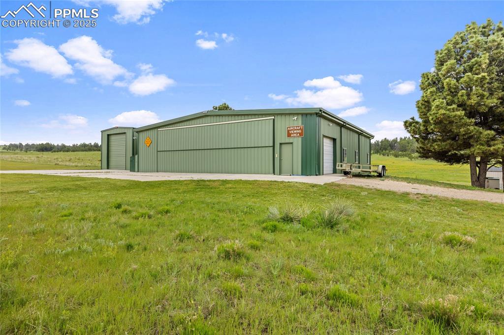 Image 9 of 41: View of pole building featuring a lawn
