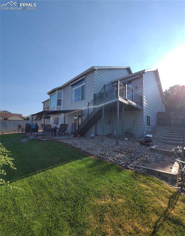 Image 2 of 11: Back of property with a patio, stairway, and a deck