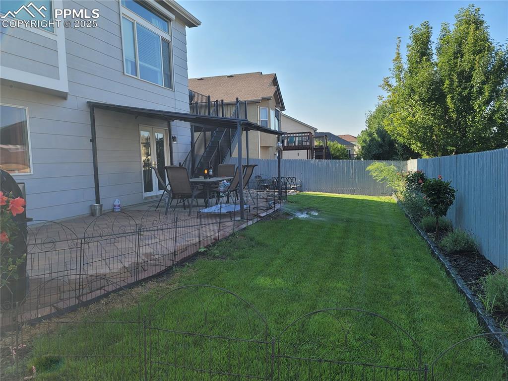 Image 4 of 11: Fenced backyard featuring a patio
