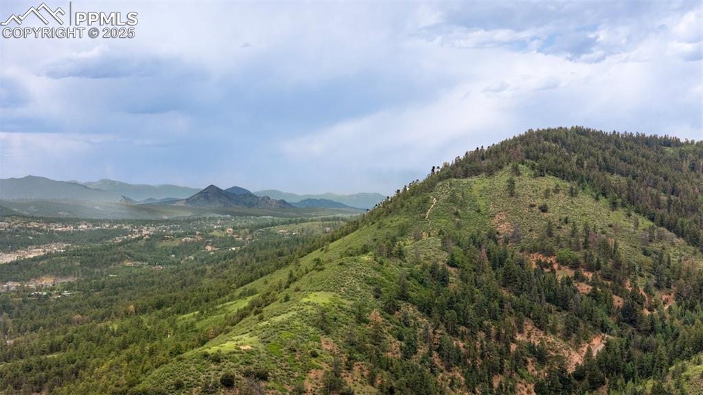 Image 20 of 21: Mountain view featuring a heavily wooded area