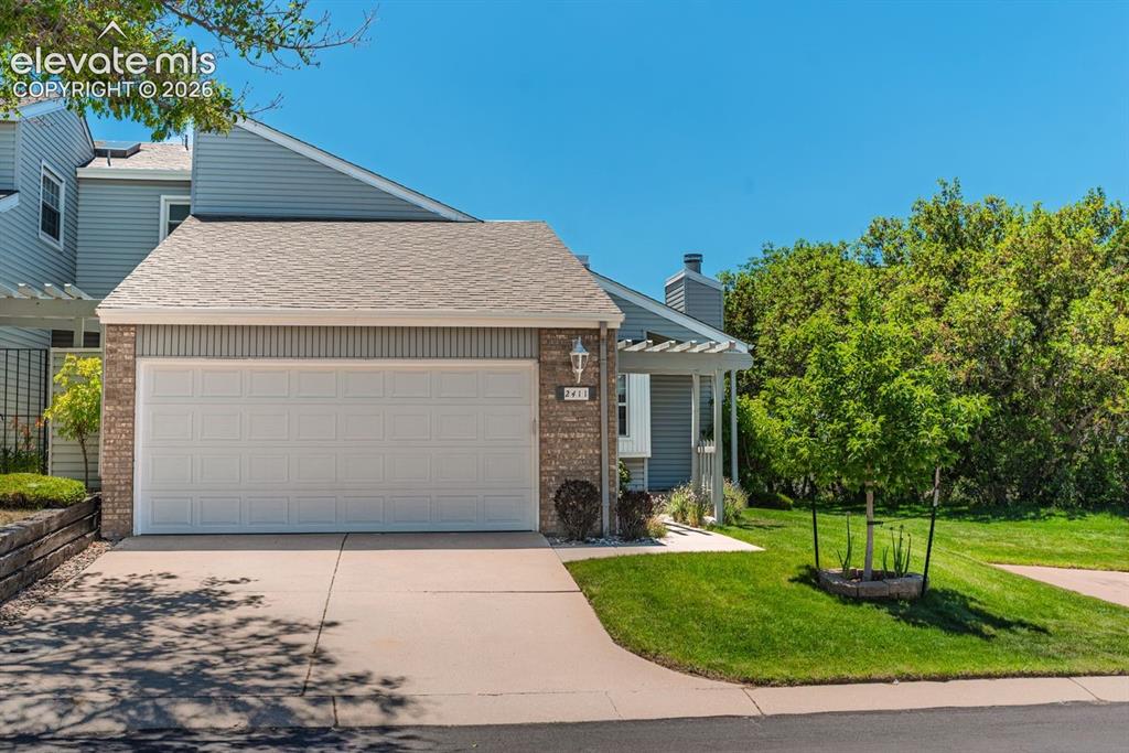 Image 2 of 36: Brick and siding exterior featuring an attached two-car garage