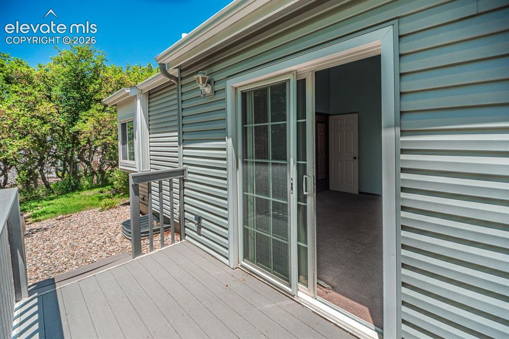 Image 23 of 36: Exterior deck with gray composite flooring and railing