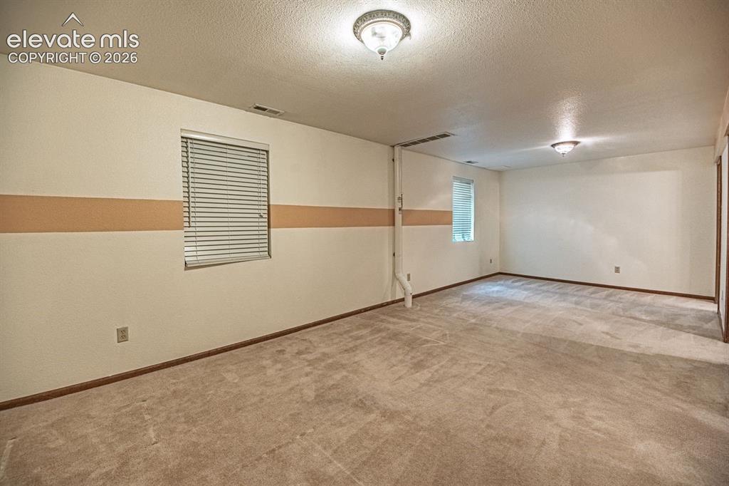 Image 29 of 36: Spacious family room or 3rd bedroom in finished basement
