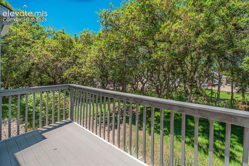 Image 35 of 36: Spacious outdoor deck with composite decking and a sturdy railing overlooki