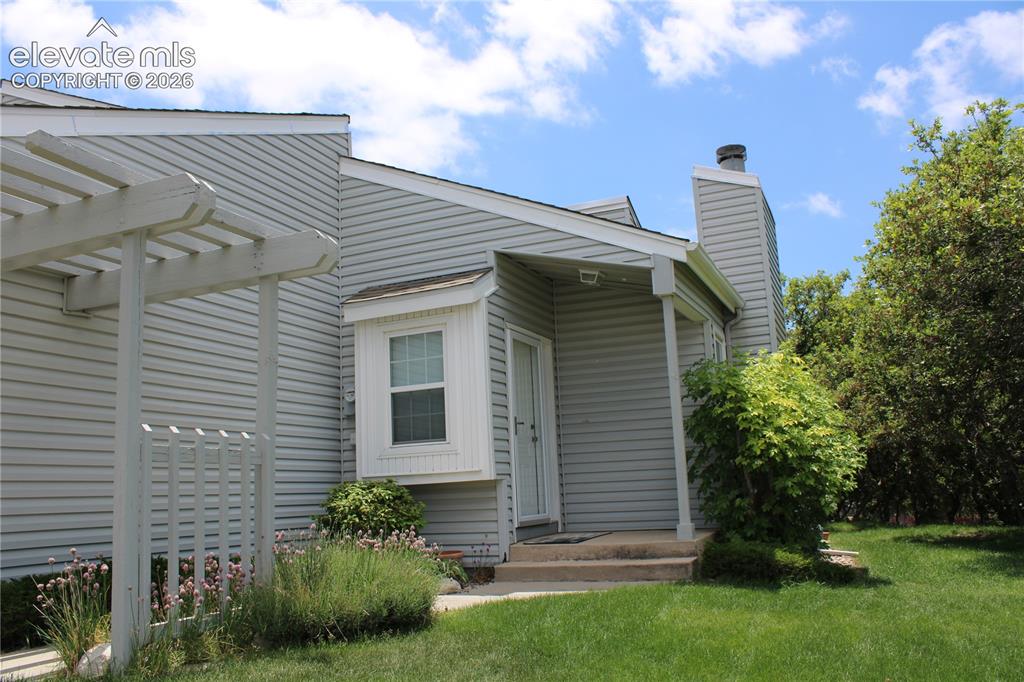 Image 36 of 36: Exterior featuring light gray horizontal siding, a covered entry, and an ar