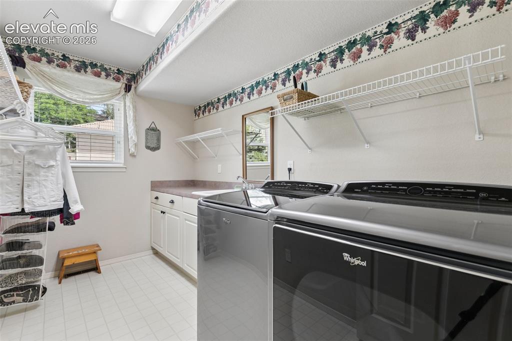 Image 16 of 49: Main Level Laundry Room with Utility Sink!