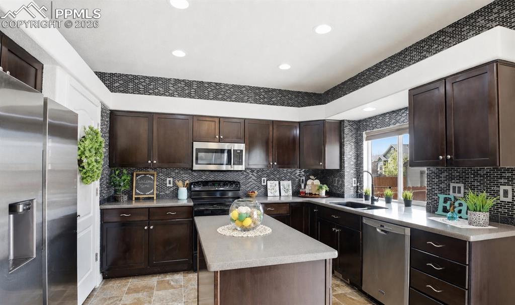 Image 19 of 49: KITCHEN OFFERING AMPLE CABINET SPACE, EXPANSIVE COUNTERTOPS, AND A NEWER RE