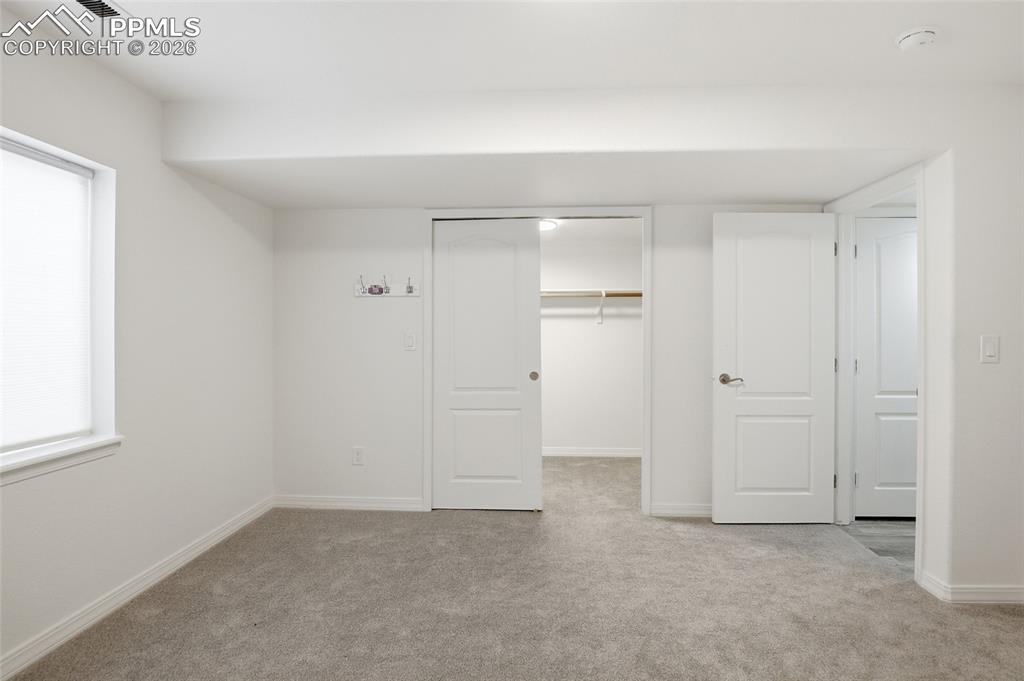 Image 40 of 49: BEDROOM 5 IN BASEMENT WITH NEW CARPET