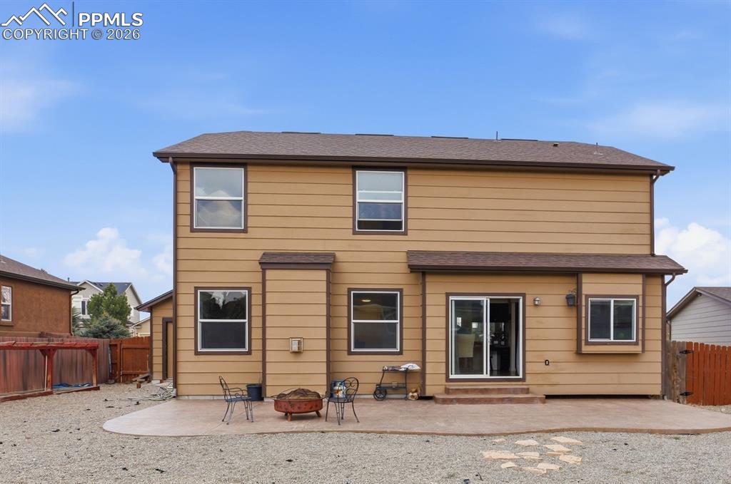 Image 43 of 49:  LARGE, FENCED BACKYARD WITH GARDEN BEDS, A STAMPED CONCRETE PATIO, AND A D