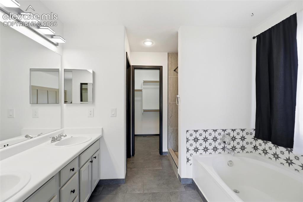 Image 17 of 48: Dual vanity with integrated sinks and a large wall mirror