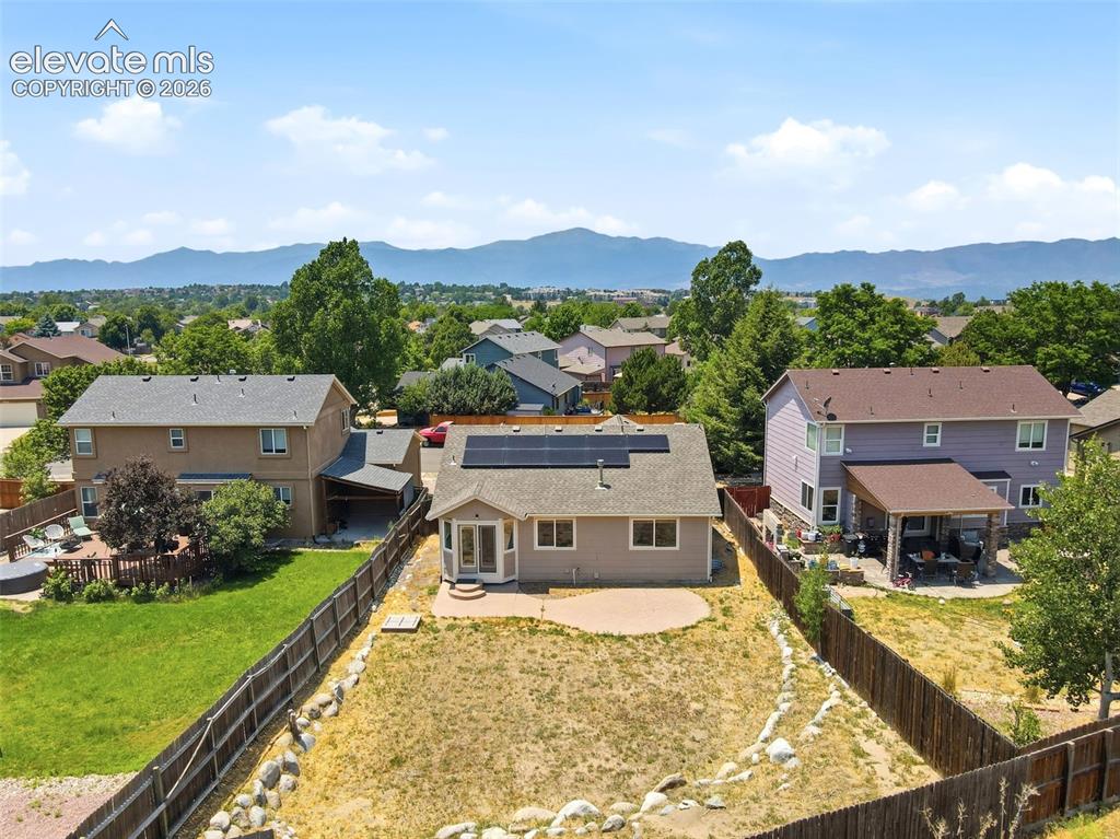 Image 34 of 48: Single-story residence featuring a neutral exterior, a paved patio, and a b