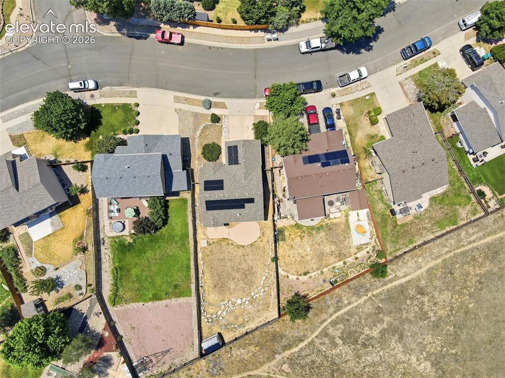 Image 38 of 48: Aerial perspective showcasing residential properties with asphalt shingle r