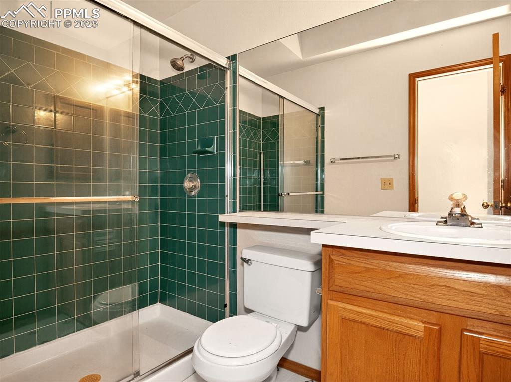 Image 13 of 26: Bathroom with vanity and a stall shower