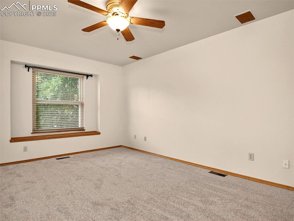 Image 14 of 26: Carpeted spare room featuring baseboards and a ceiling fan