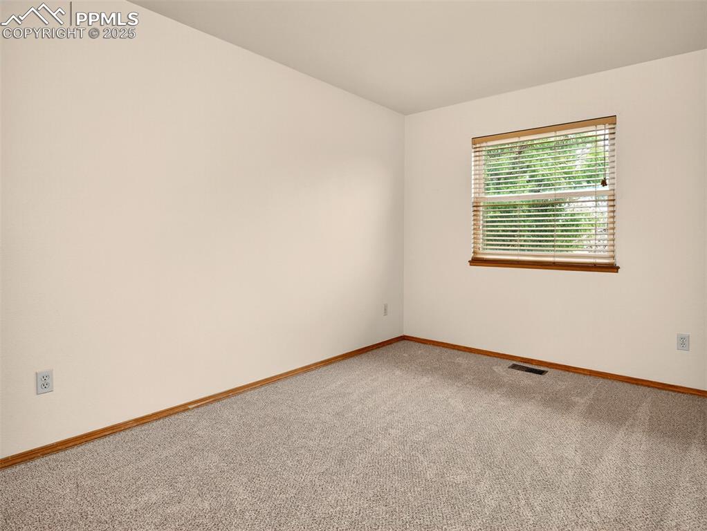 Image 17 of 26: Carpeted spare room featuring baseboards