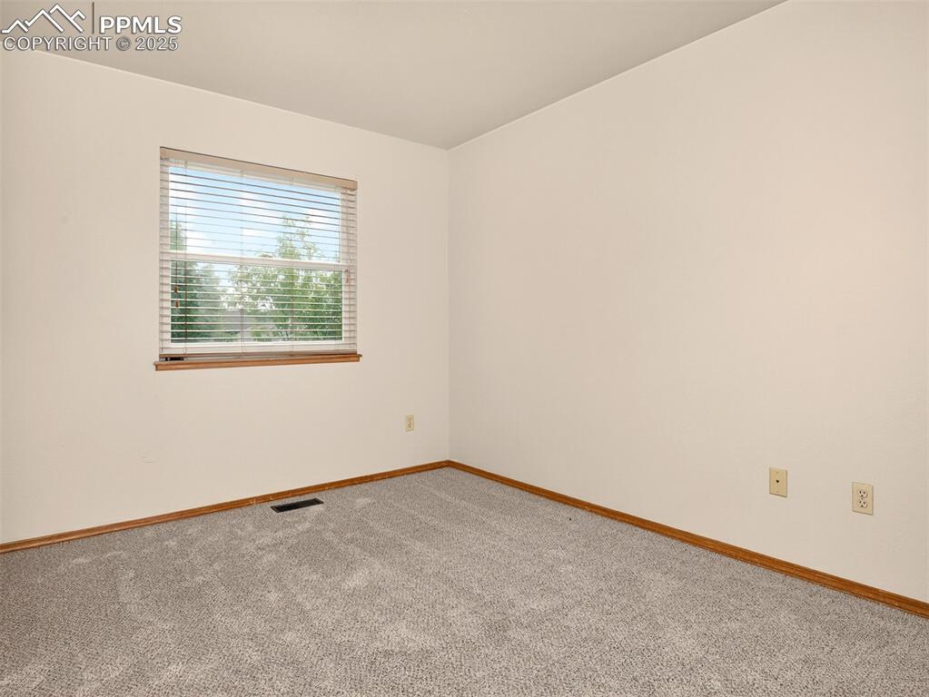 Image 19 of 26: Carpeted spare room featuring baseboards
