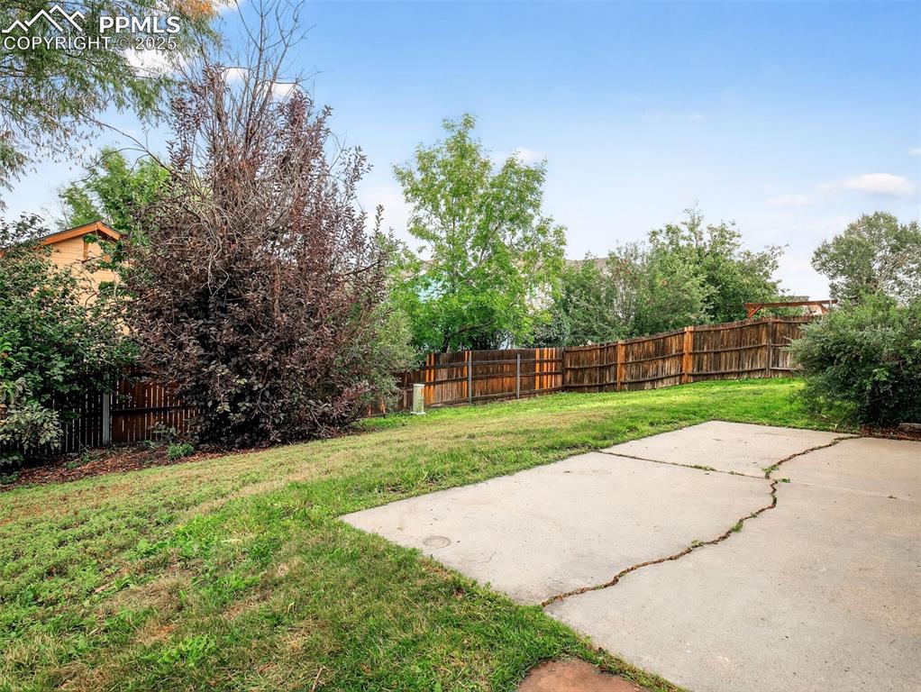 Image 24 of 26: Fenced backyard featuring a patio area