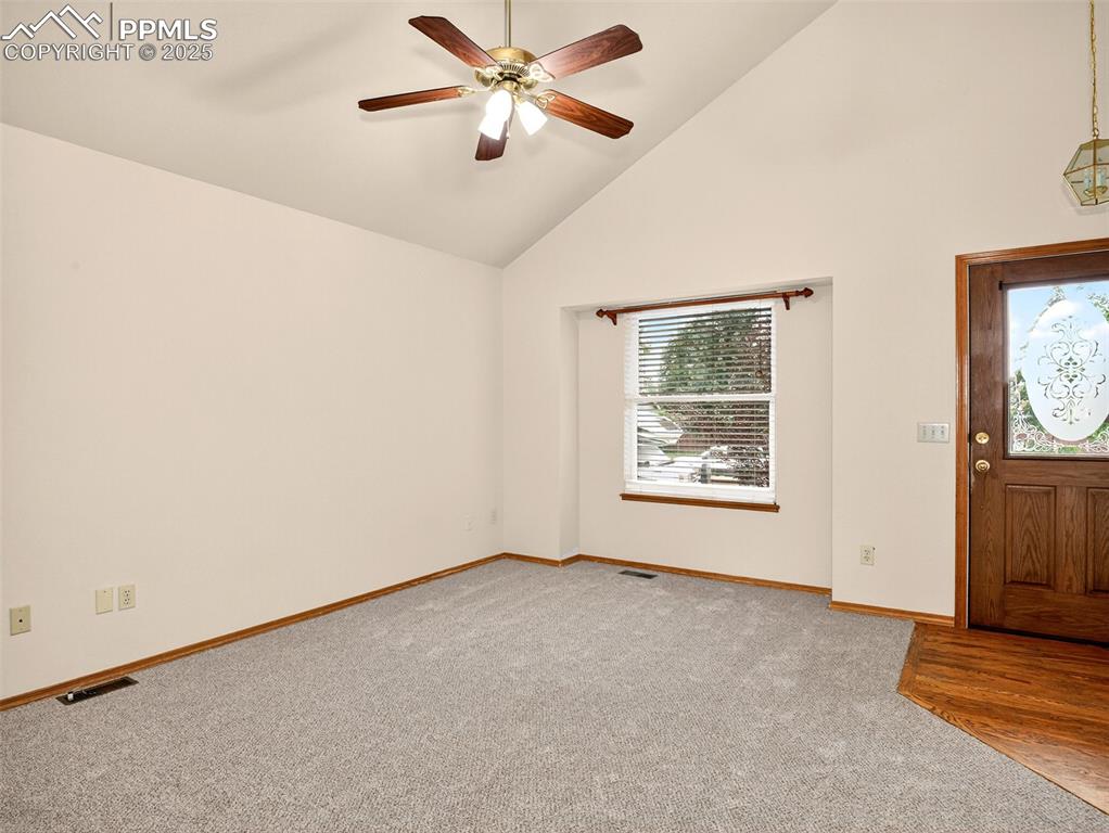 Image 5 of 26: Entrance foyer with high vaulted ceiling, light colored carpet, and ceiling
