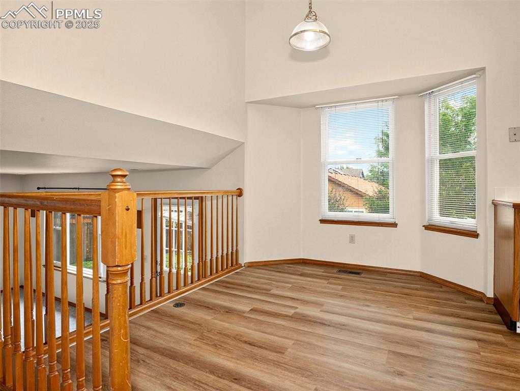 Image 9 of 26: Spare room with plenty of natural light, light wood-style flooring, and a h