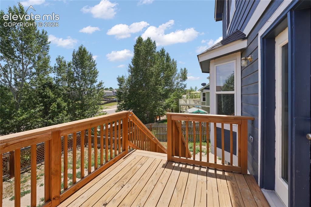 Image 32 of 36: Expansive multi-level wood deck with natural wood railings, providing outdo
