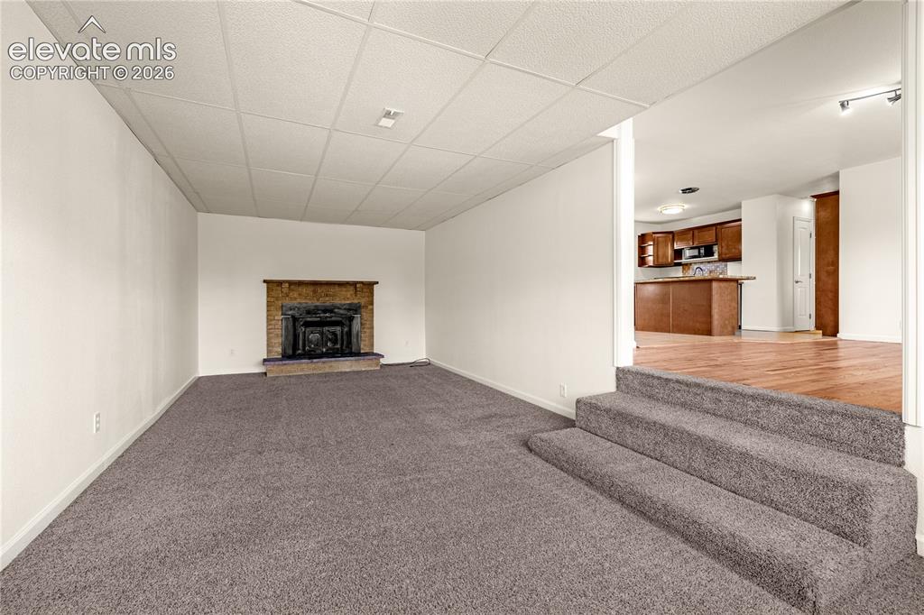 Image 10 of 43: Living Room, wood burning fireplace