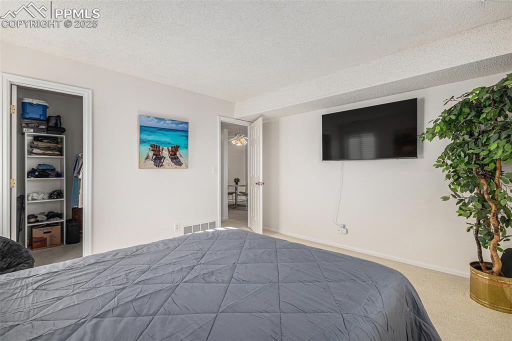 Image 10 of 19: Walk-in closet in bedroom