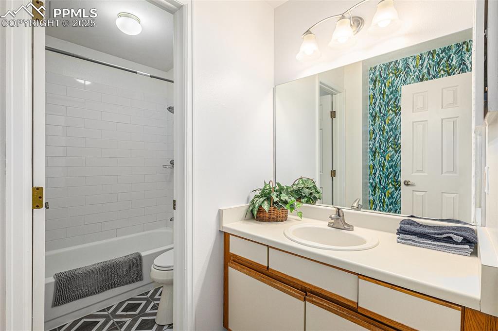 Image 11 of 19: Updated tile in bathroom