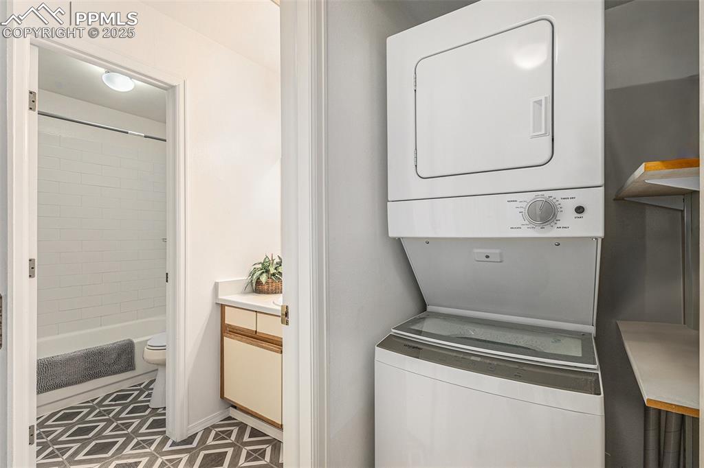 Image 12 of 19: Convenient stackable washer/dryer off of bathroom