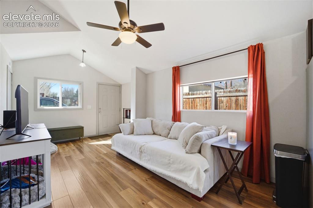 Image 15 of 30: Open-concept living space with vaulted ceilings