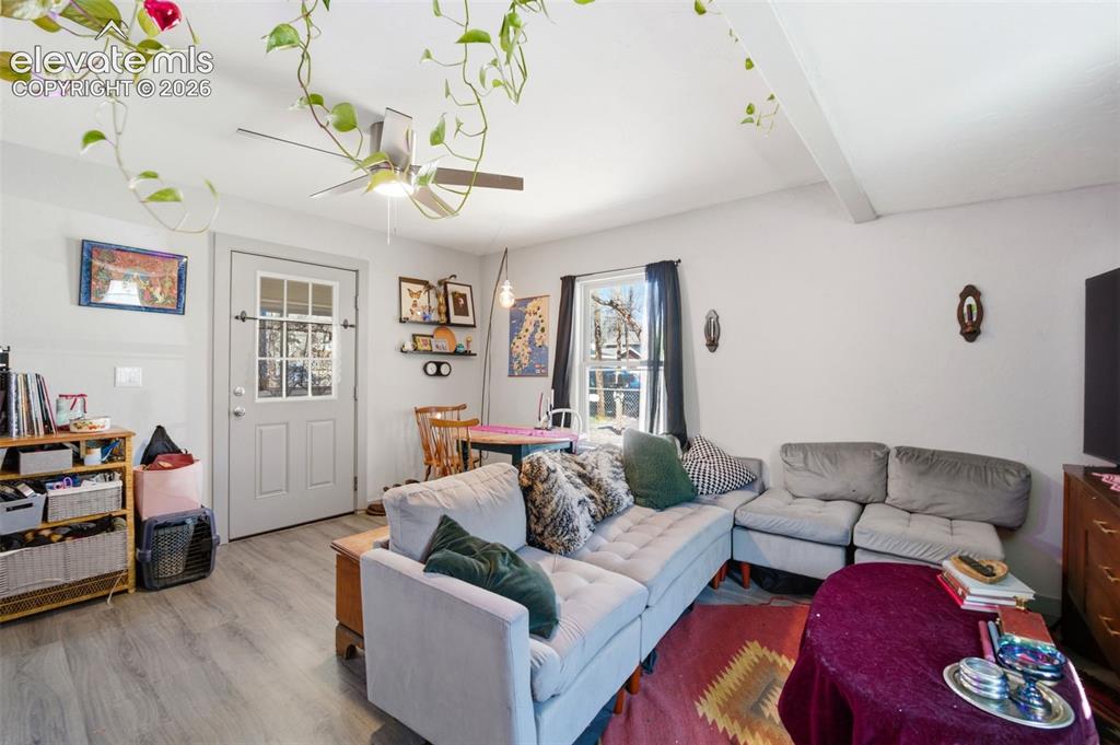 Image 3 of 30: Living area featuring wood-finish flooring and a ceiling fan