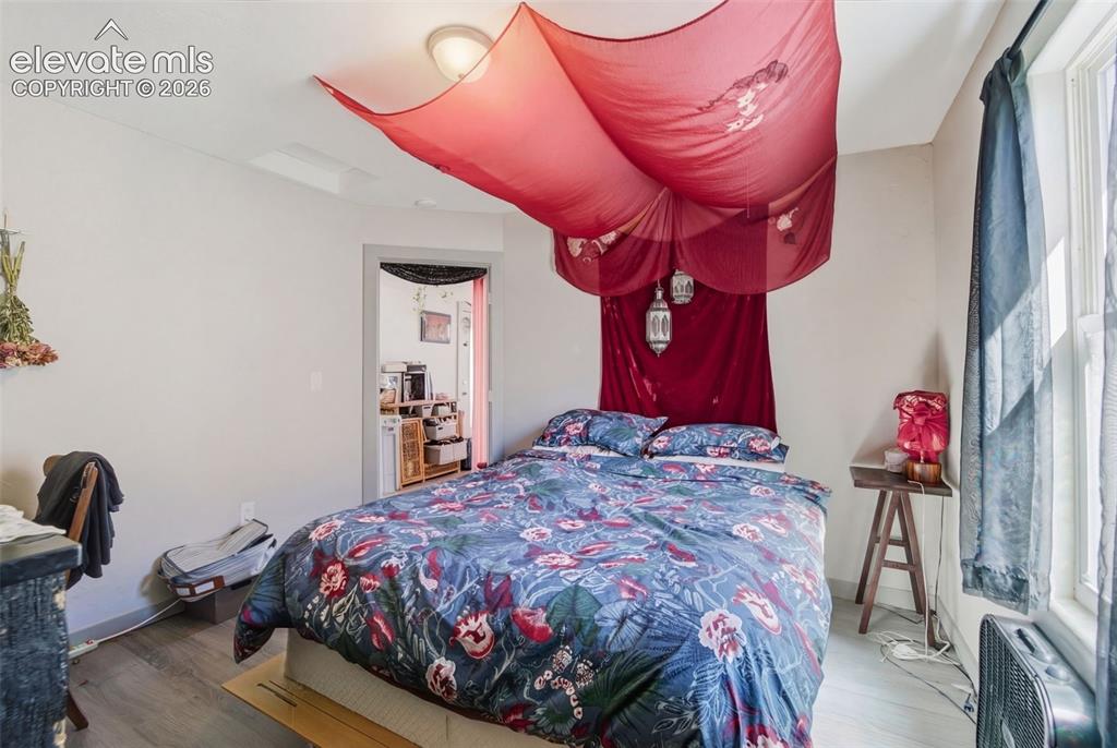 Image 8 of 30: Room featuring light-colored walls and wood-finish flooring