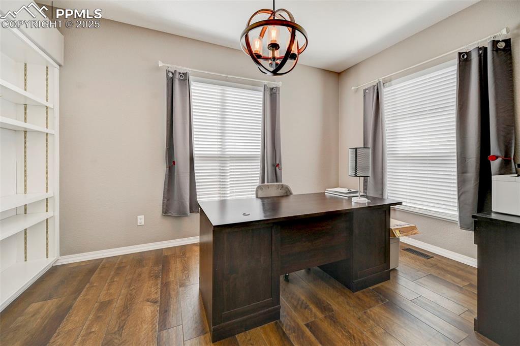 Image 13 of 31: Office with baseboards, an inviting chandelier, visible vents, and plenty o