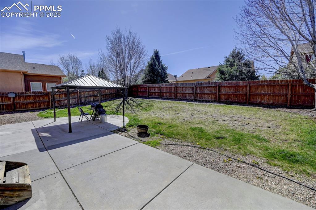 Image 29 of 31: View of patio / terrace featuring a fenced backyard and a gazebo
