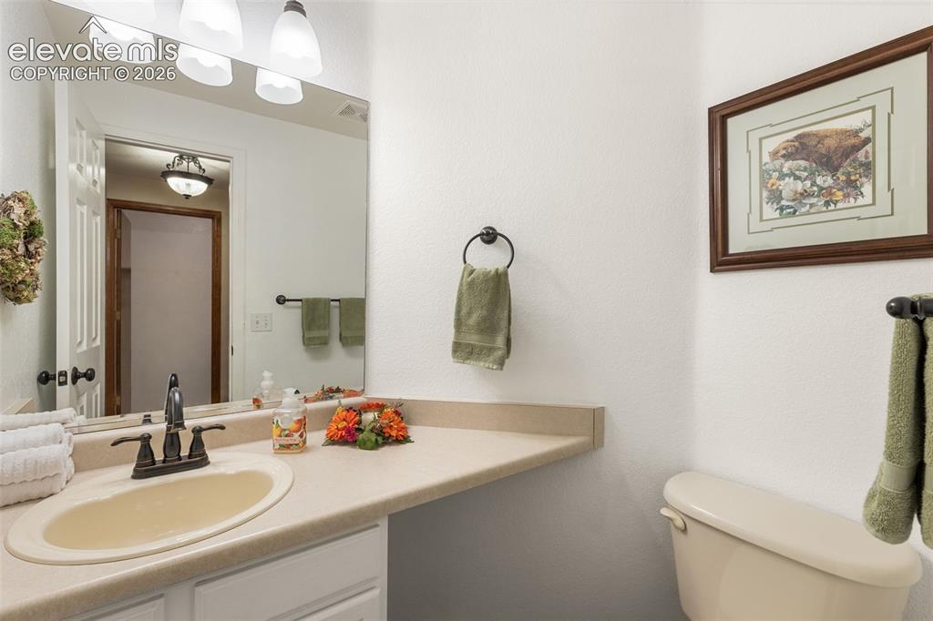Image 17 of 47: Half bath located on main level near living room.