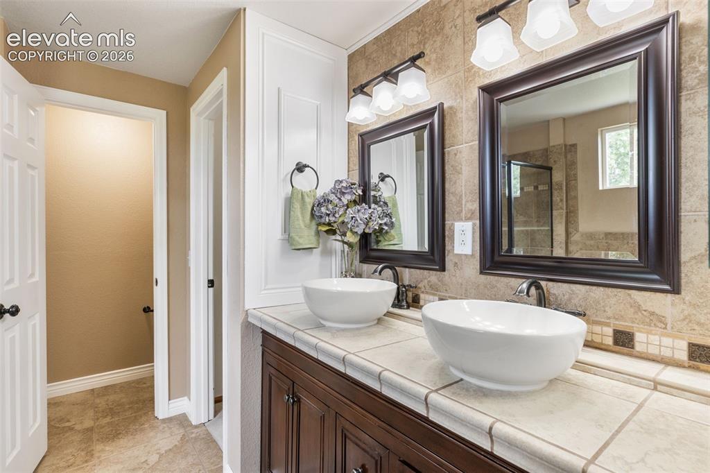 Image 23 of 47: En suite 5 piece primary bathroom with natural light, soaking tub, walk-in 