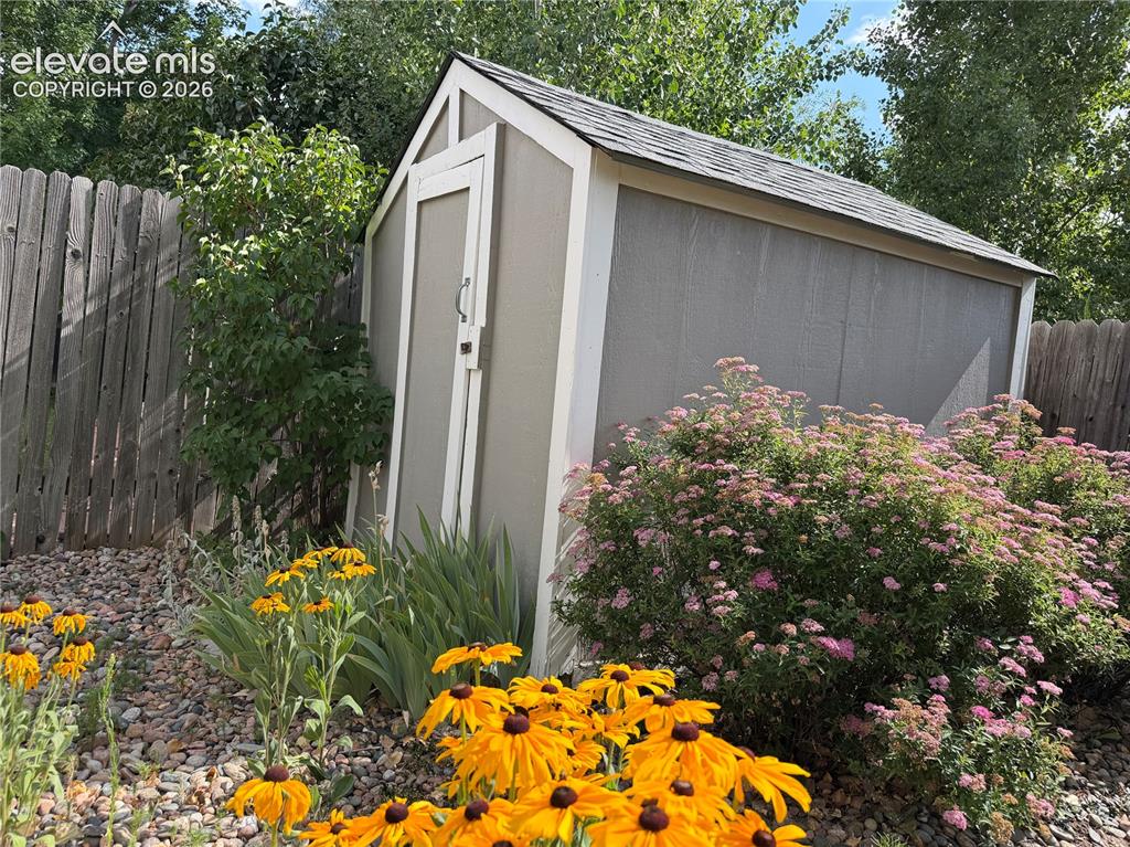Image 39 of 47: Shed for additional storage and stunning garden.