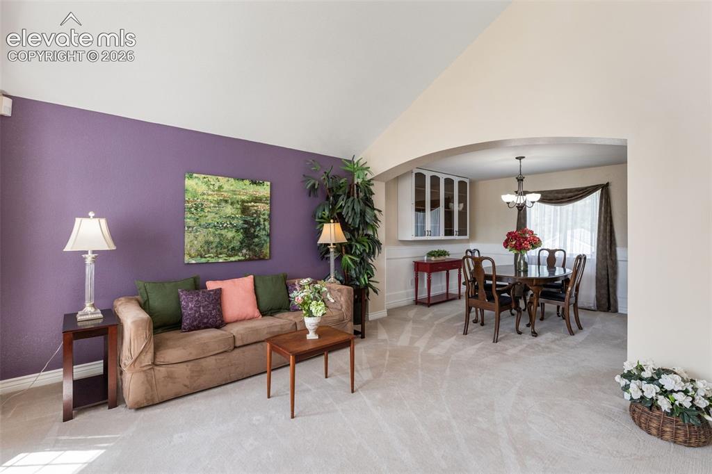 Image 4 of 47: Living room anchored with windows that illuminate the space.