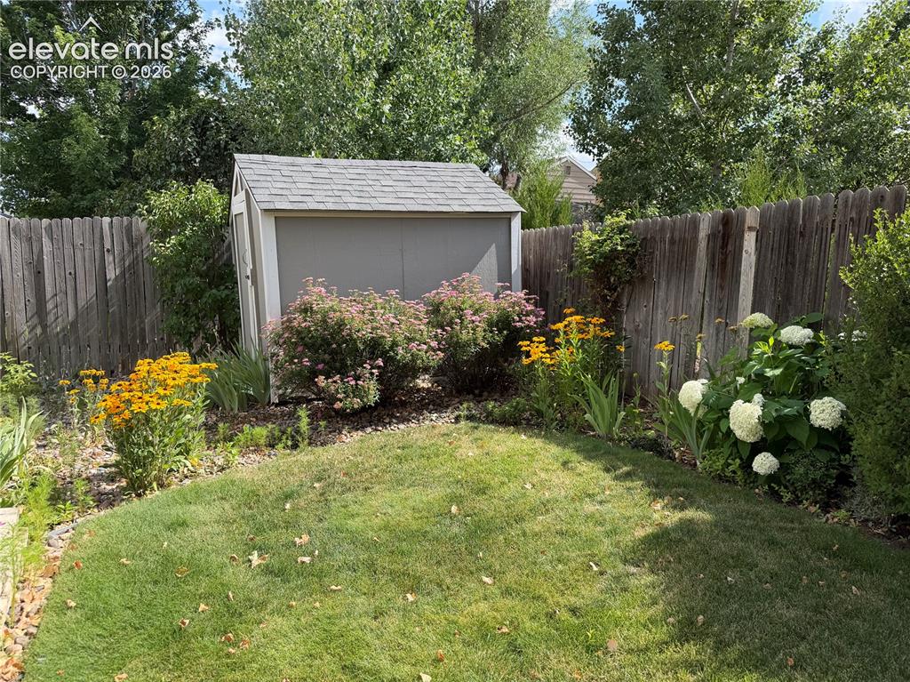 Image 41 of 47: Established perennial flower garden with beautiful daisy, lilac, hydrangea,