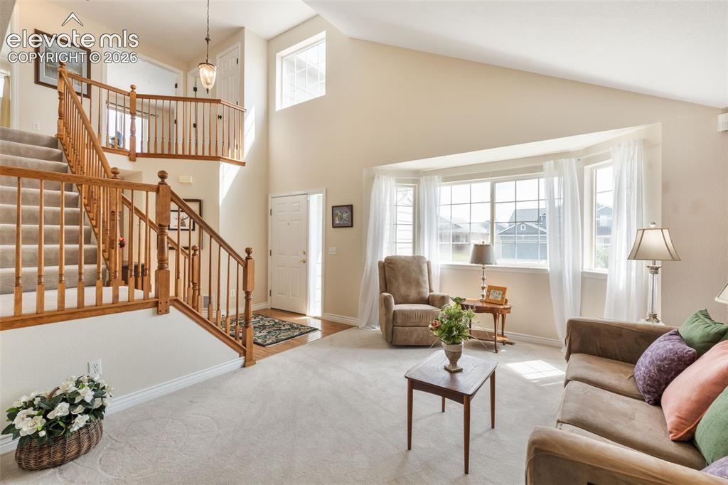 Image 5 of 47: Living room anchored with windows that illuminate the space.