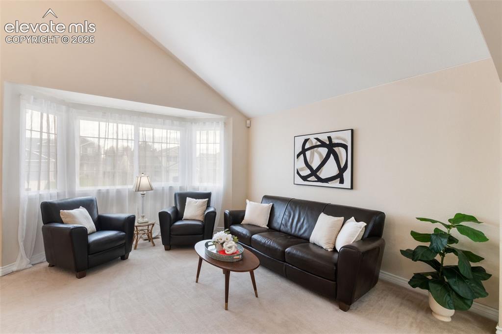 Image 5 of 50: Living room with bright picture windows.