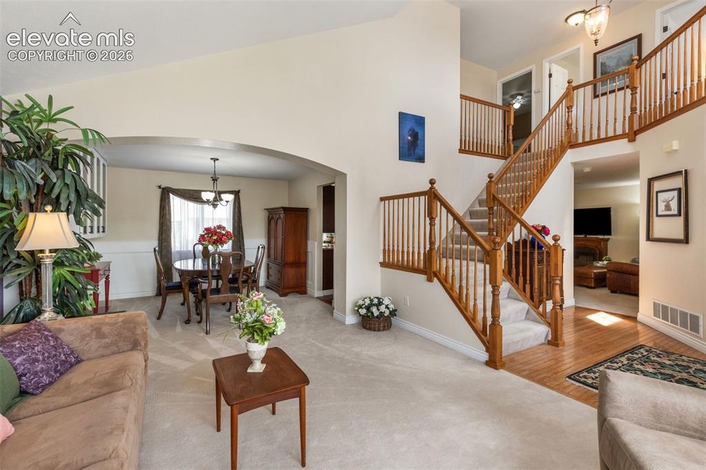 Image 6 of 47: Living room anchored with windows that illuminate the space.