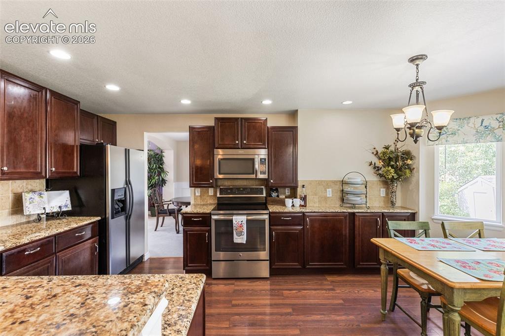 Image 9 of 47: Kitchen is accessible to both family room and dining room.