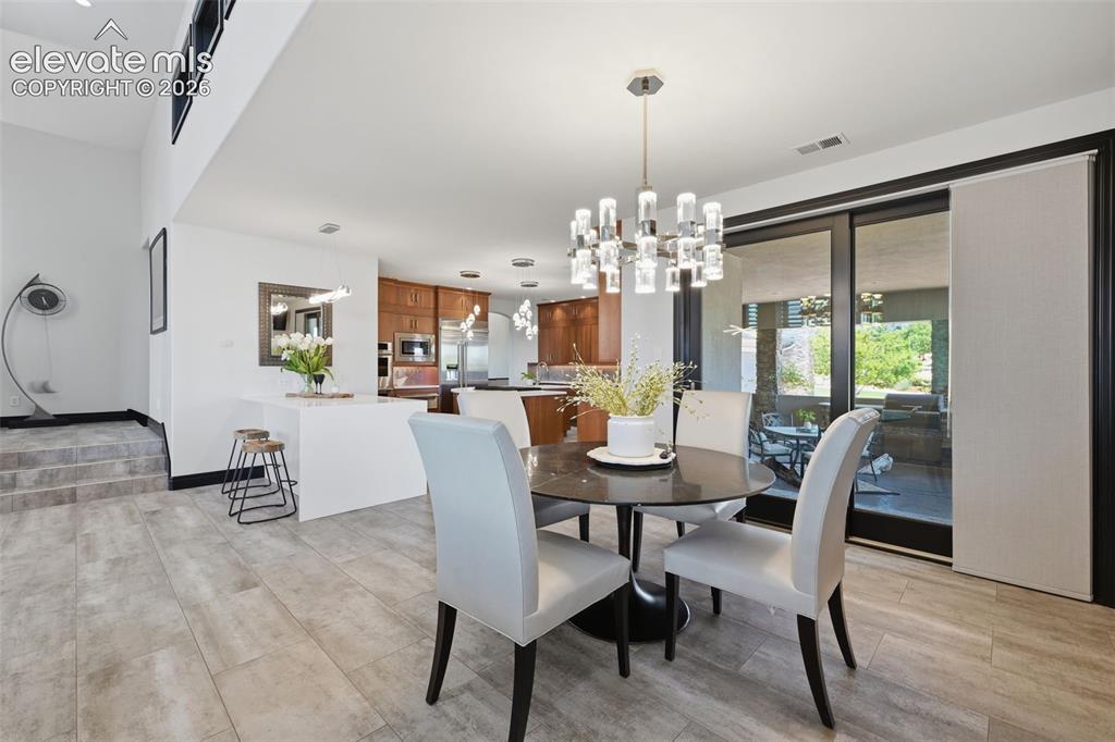 Image 15 of 48: Kitchen and outdoor kitchen! Water fall quartz counters!