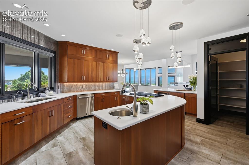Image 18 of 48: Another view of kitchen with large pantry, updated lighting and open floor