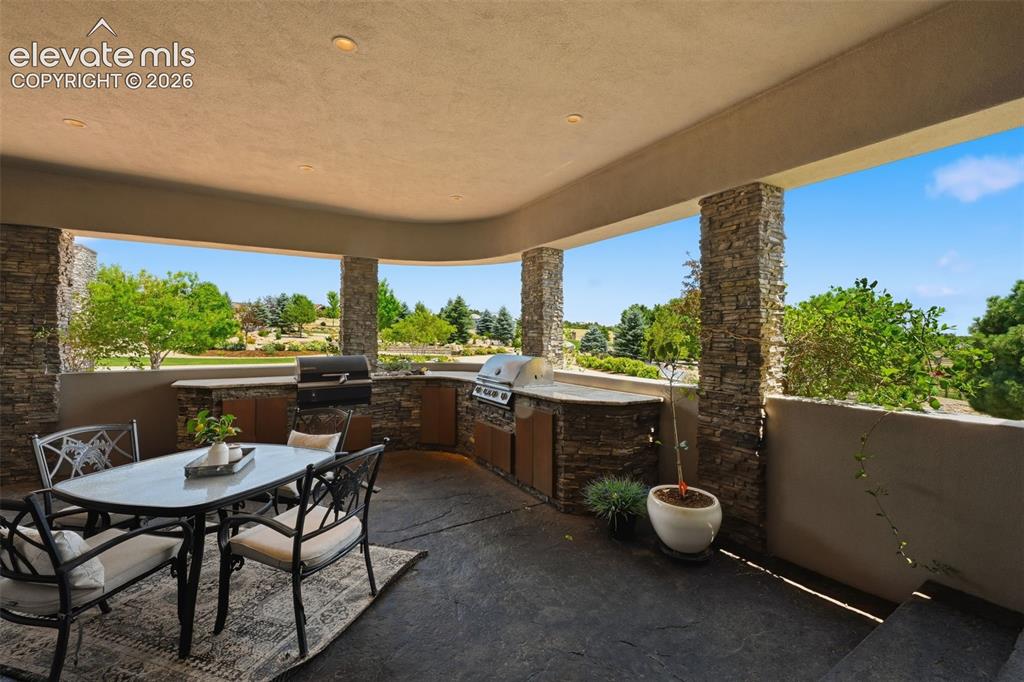 Image 20 of 48: Covered outdoor kitchen on the east side of the home!