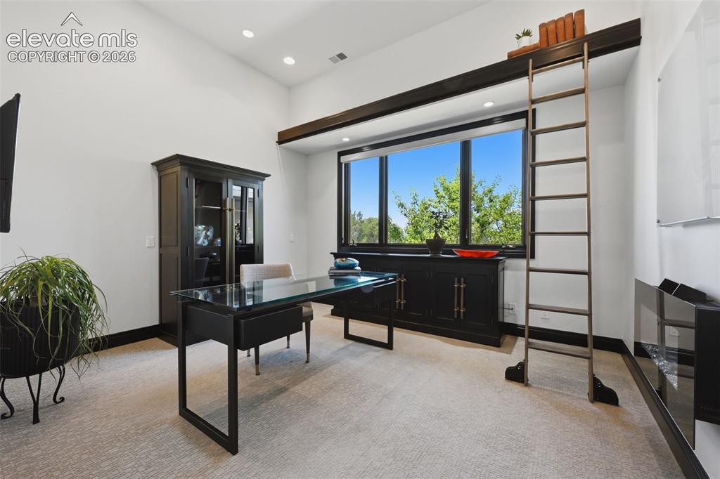Image 28 of 48: Main level office with more views and attached ladder storage!