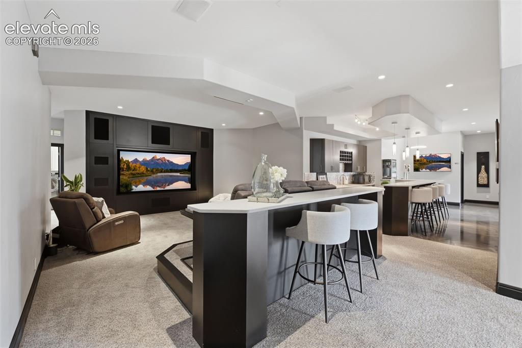 Image 36 of 48: Media room in the basement and wet bar!